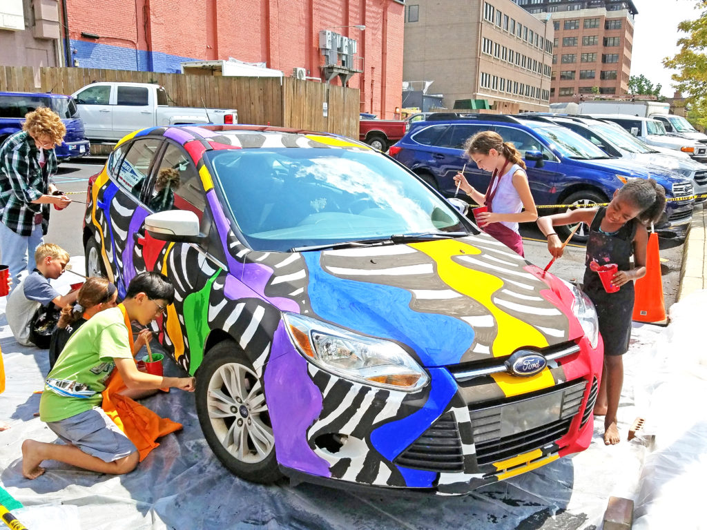 Children painting Jean's car