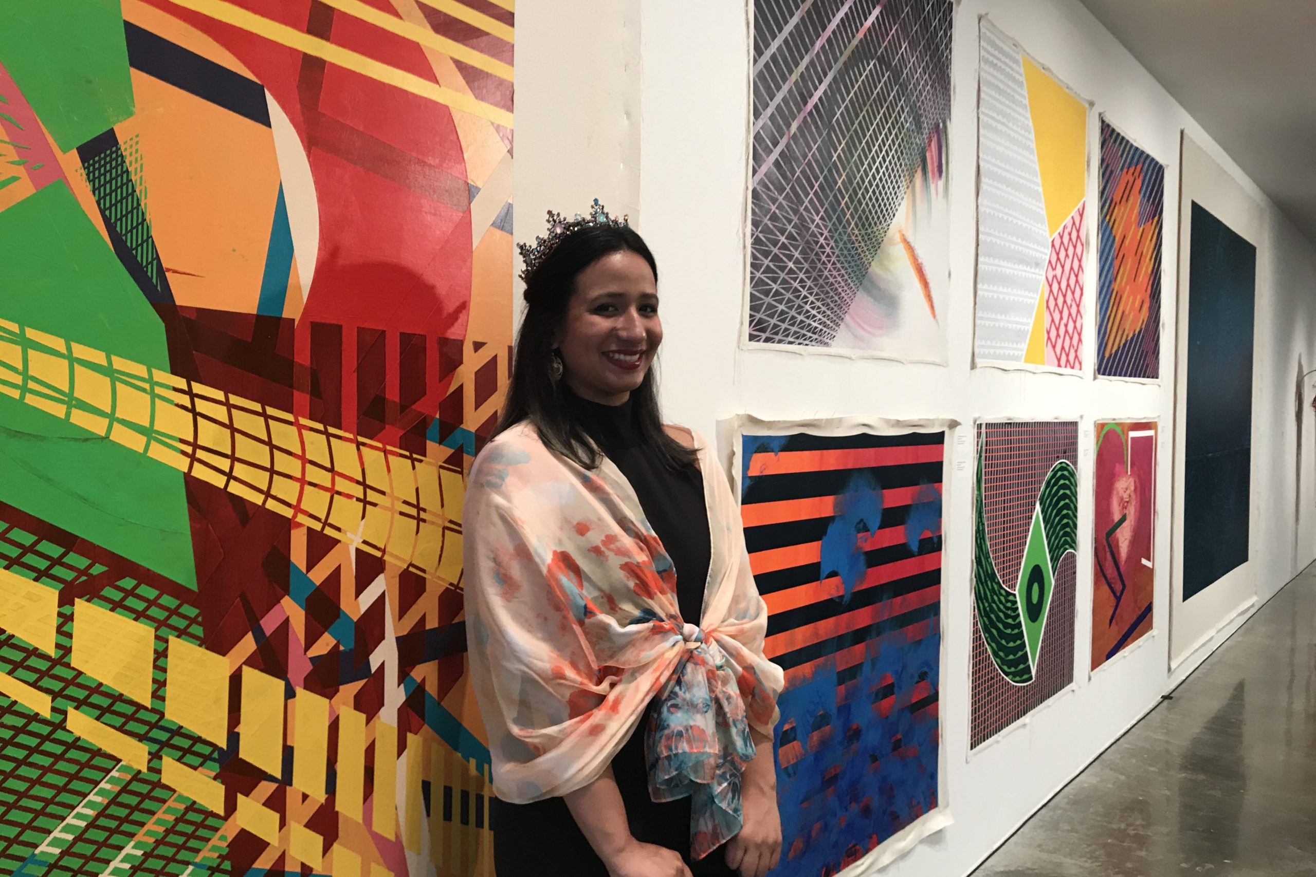 Sonimar in front of her paintings.